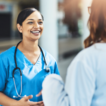 A group of medical professionals engaged in conversation, representing the importance of mental health support for doctors and healthcare workers. The image highlights collaboration, resilience, and well-being in the medical field.